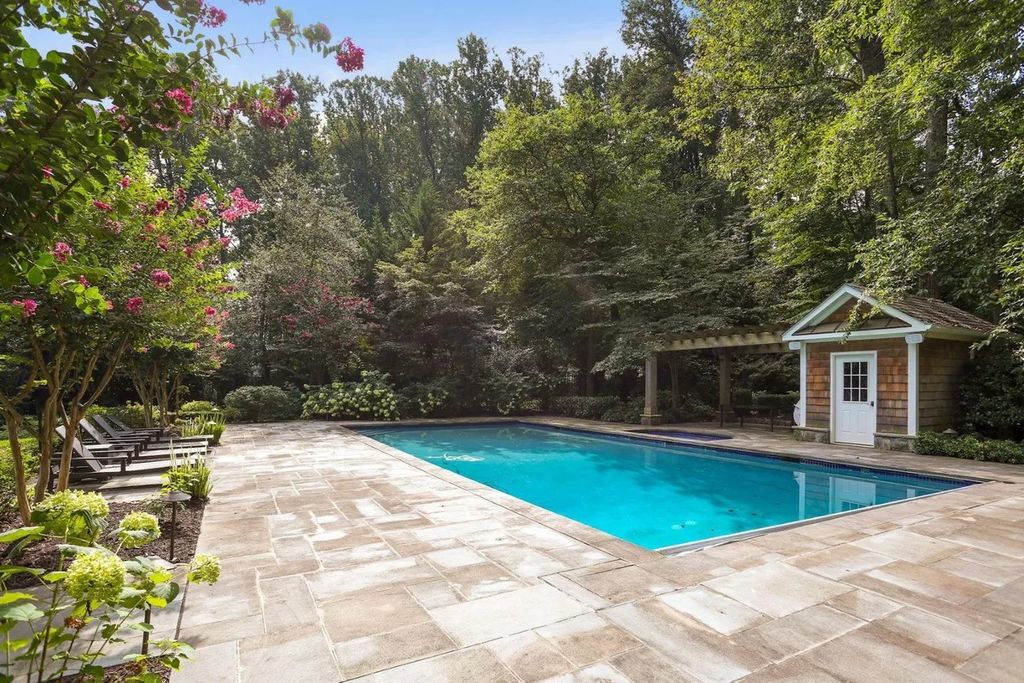 The Residence in McLean offers panoramic views of the landscaped grounds with multiple French doors to the gardens, stone walkways, now available for sale. This home located at 8425 Sparger St, McLean, Virginia
