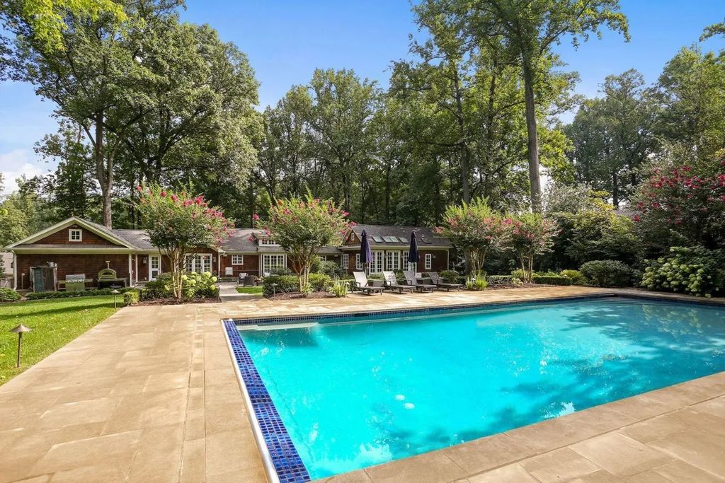 The Residence in McLean offers panoramic views of the landscaped grounds with multiple French doors to the gardens, stone walkways, now available for sale. This home located at 8425 Sparger St, McLean, Virginia