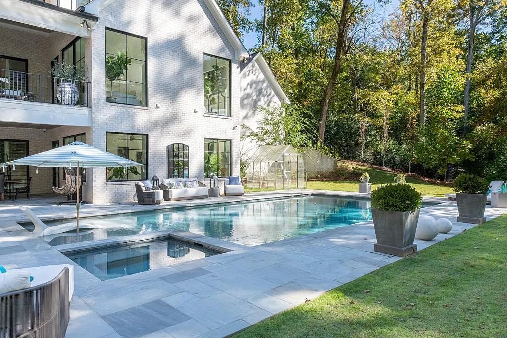 The Property in Atlanta boasts both a main & upper-level luxurious, primary suite, an elevator, hard to find 5 car, now available for sale. This home located at 4220 Harris Trl NW, Atlanta, Georgia