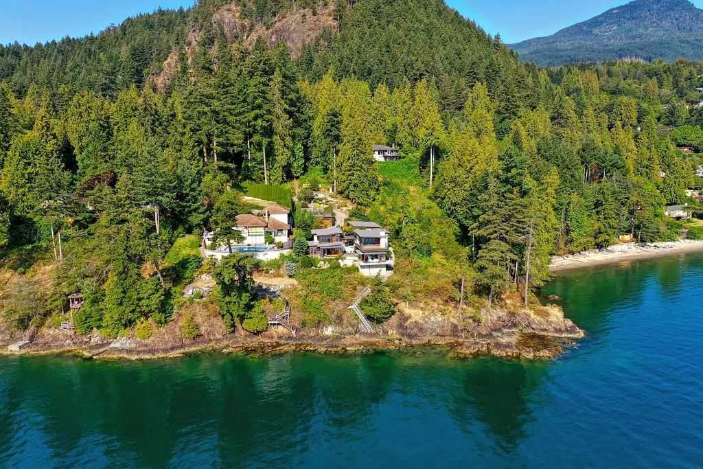 The Estate in Gibsons is a luxurious home offering exceptional privacy with a gorgeous mature landscaping and ocean views now available for sale. This home located at 1012 Marine Dr, Gibsons, BC V0N 1V1, Canada; offering 03 bedrooms and 04 bathrooms with 3,944 square feet of living spaces.