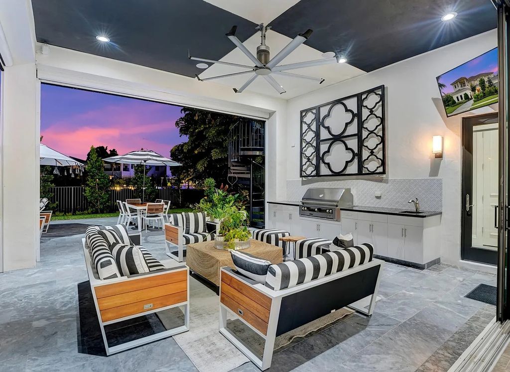 16825 Matisse Drive, Delray Beach, Florida is a beautiful resort style home comes with modern floor plan, winding wood staircase, a media room, wet bar & gaming area, summer kitchen, putting green, retractable doors, and more. 