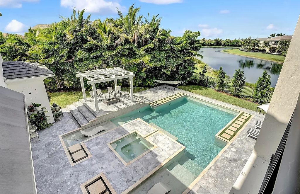 16825 Matisse Drive, Delray Beach, Florida is a beautiful resort style home comes with modern floor plan, winding wood staircase, a media room, wet bar & gaming area, summer kitchen, putting green, retractable doors, and more. 