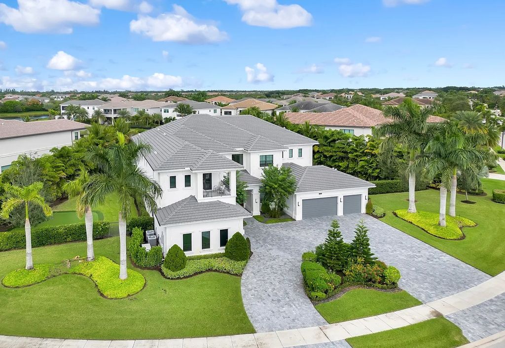 16825 Matisse Drive, Delray Beach, Florida is a beautiful resort style home comes with modern floor plan, winding wood staircase, a media room, wet bar & gaming area, summer kitchen, putting green, retractable doors, and more. 