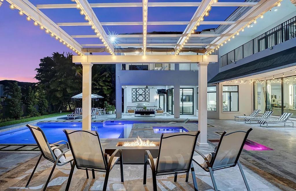 16825 Matisse Drive, Delray Beach, Florida is a beautiful resort style home comes with modern floor plan, winding wood staircase, a media room, wet bar & gaming area, summer kitchen, putting green, retractable doors, and more. 