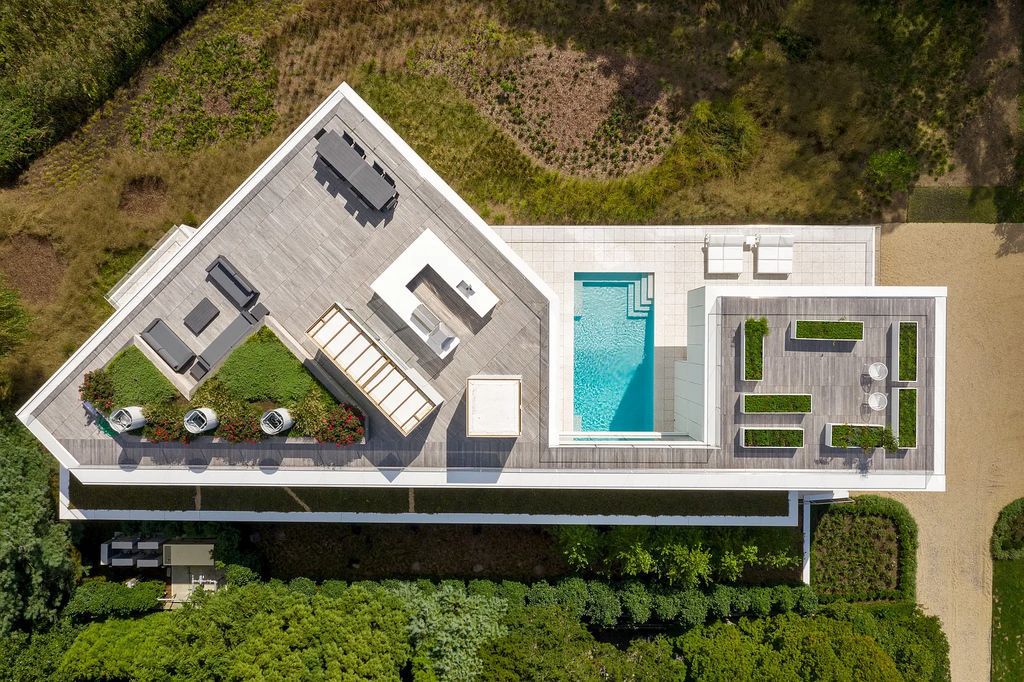 34 Cobb Isle Road, Water Mill, New York is a contemporary architectural masterpiece by renowned architect Roger Ferris overlooking Mecox Bay and the Atlantic Ocean, with 2 docks, plus a fully restored guest house on its own single and separate lot.