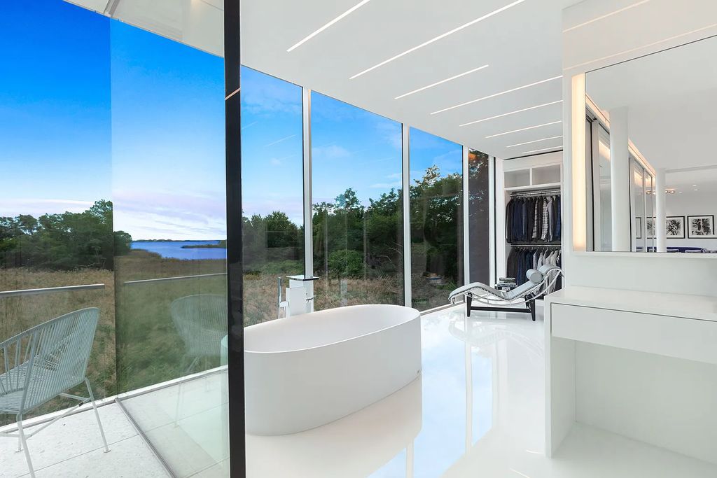 34 Cobb Isle Road, Water Mill, New York is a contemporary architectural masterpiece by renowned architect Roger Ferris overlooking Mecox Bay and the Atlantic Ocean, with 2 docks, plus a fully restored guest house on its own single and separate lot.