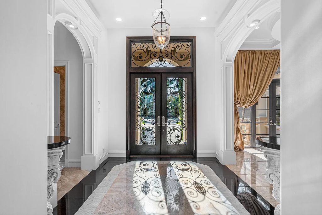 9179 Redonda Drive, Boca Raton, Florida is a custom lakefront Chateau in the prestigious Sanctuary section of The Oaks set on a special expansive lot with endless long lake views. 