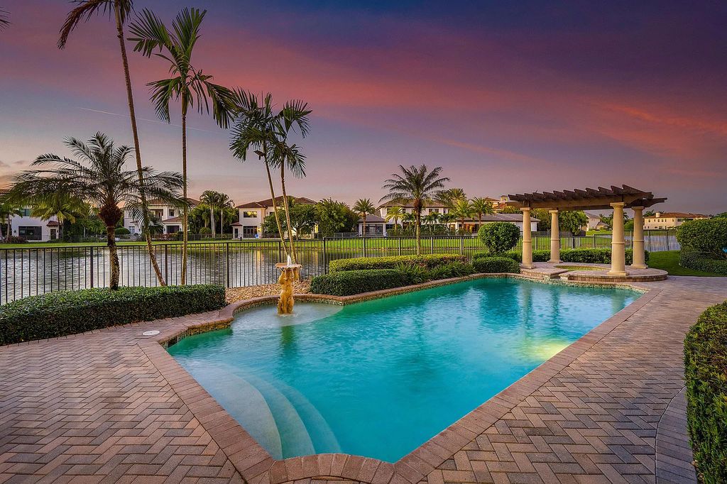 9179 Redonda Drive, Boca Raton, Florida is a custom lakefront Chateau in the prestigious Sanctuary section of The Oaks set on a special expansive lot with endless long lake views. 