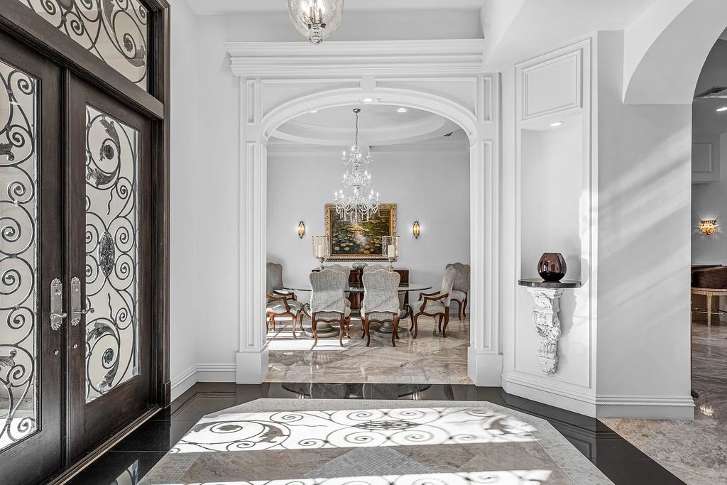 9179 Redonda Drive, Boca Raton, Florida is a custom lakefront Chateau in the prestigious Sanctuary section of The Oaks set on a special expansive lot with endless long lake views. 