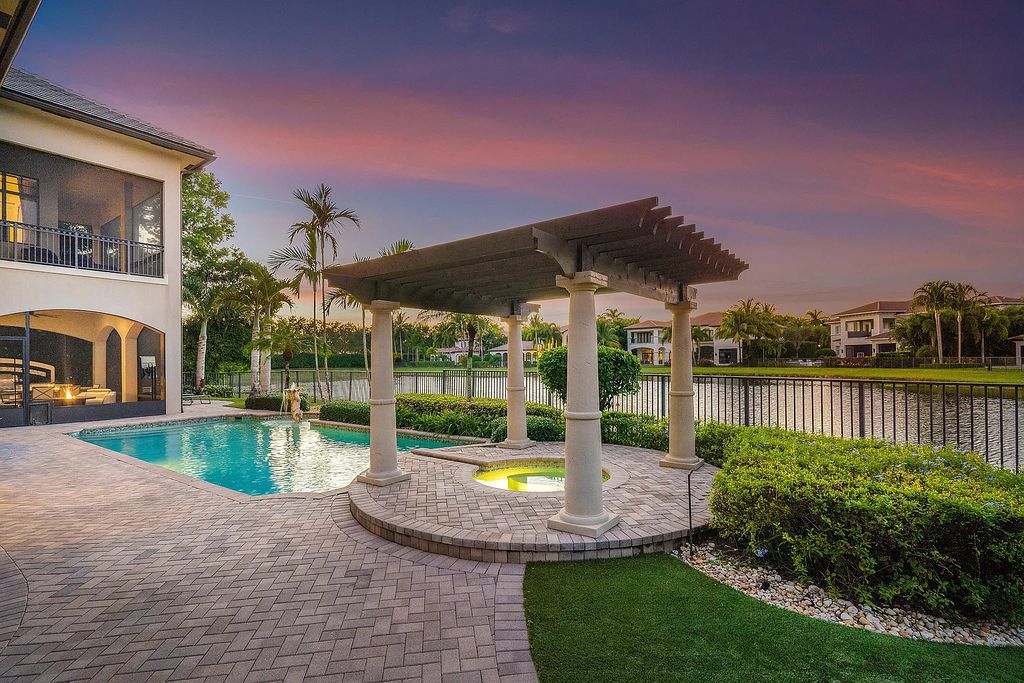 9179 Redonda Drive, Boca Raton, Florida is a custom lakefront Chateau in the prestigious Sanctuary section of The Oaks set on a special expansive lot with endless long lake views. 