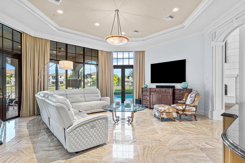 9179 Redonda Drive, Boca Raton, Florida is a custom lakefront Chateau in the prestigious Sanctuary section of The Oaks set on a special expansive lot with endless long lake views. 