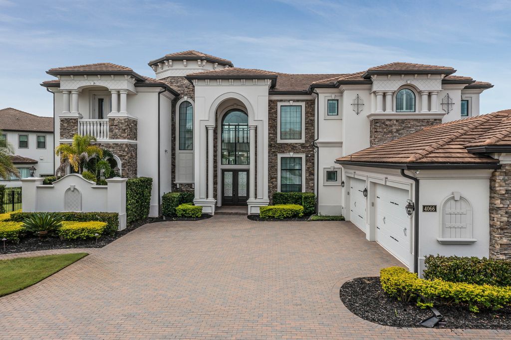 4066 Isabella Circle, Windermere, Florida is a spectacular home with beautiful porcelain floors, high-end appliances, accent wall, expensive light features, and an amazing backyard and gorgeous views.