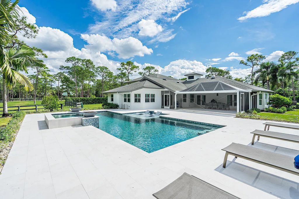14165 Banded Racoon Drive, Palm Beach Gardens, Florida is an exquisite residence perfectly proportioned usable five acres with a breath of fresh air to equestrian architecture and design.