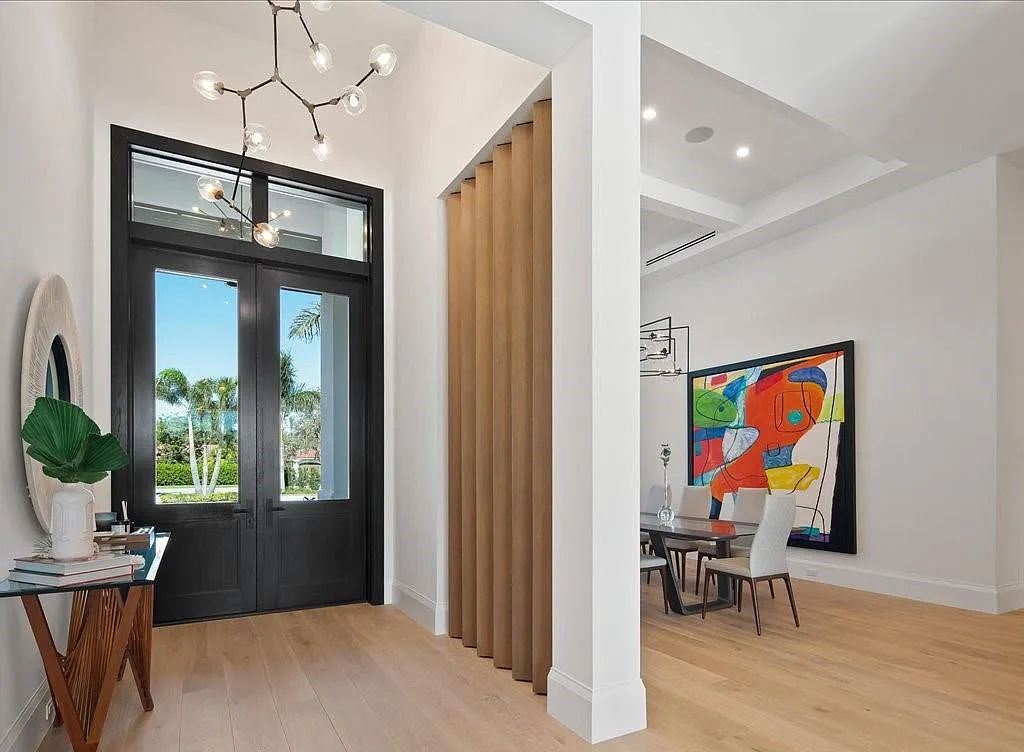 62 Ridge Drive, Naples, Florida is a captivating and stylish home with an expansive living room, an ultimate outdoor area, an office, a laundry room, and an attached 3-car garage and more.