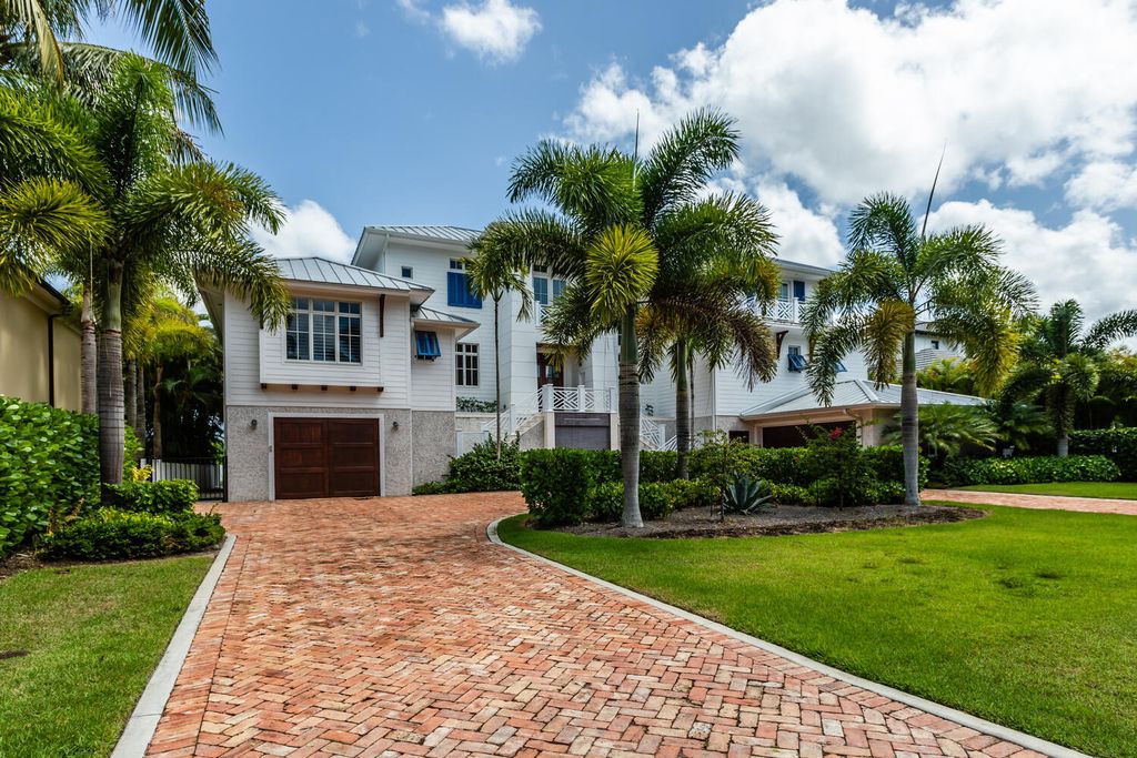 481 21st Ave S, Naples, Florida is a one-of-a-kind estate nestled along the widest canal in Aqualane Shore with hardwood flooring, shiplap siding and outstanding finishes, enhanced by mesmerizing water views.