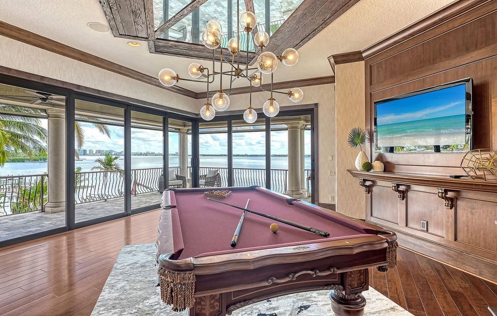 1436 John Ringling Parkway, Sarasota, Florida is a magnificent home in the coveted neighborhood of Lido Shores with impressive architectural details, beautiful chandeliers, custom woodwork, and pristine views of Sarasota Bay.