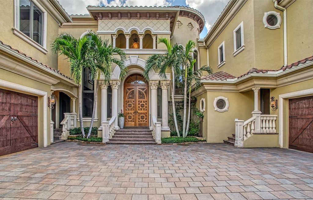 1436 John Ringling Parkway, Sarasota, Florida is a magnificent home in the coveted neighborhood of Lido Shores with impressive architectural details, beautiful chandeliers, custom woodwork, and pristine views of Sarasota Bay.