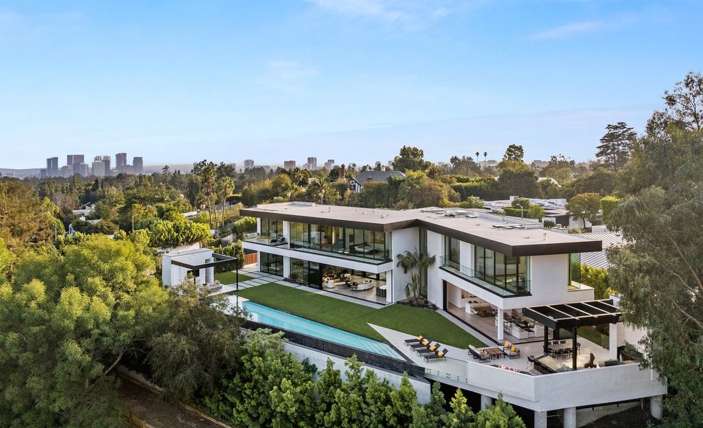 1130 Angelo Drive, Beverly Hills, California is a stunning 2022 new organic architectural gem set in the most desirable zip code in the world showcases sweeping views of Downtown Los Angeles and Century City.