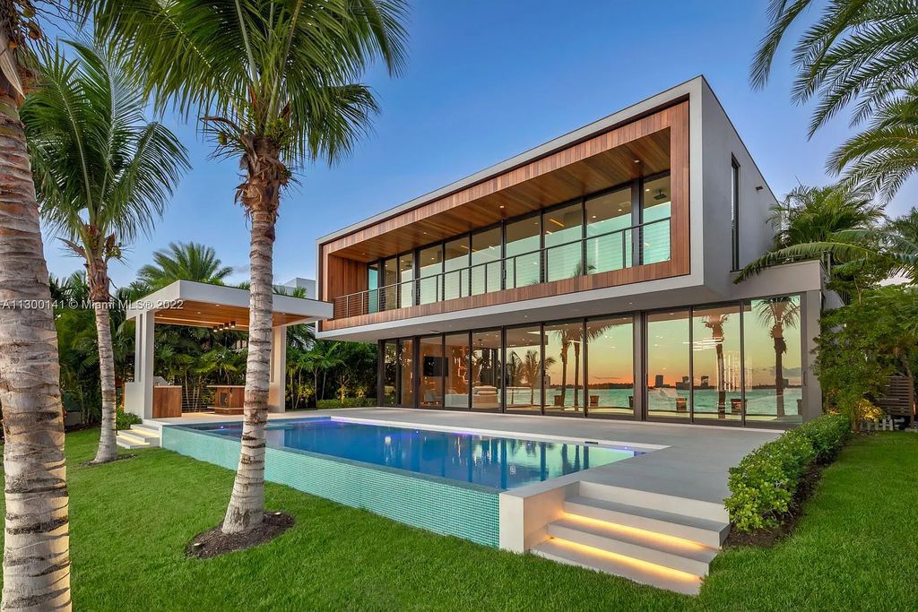 9530 W Broadview Drive, Bay Harbor Islands, Florida is a tropical modern masterpiece with architecture by Choeff Levy Fischman, interior design by CBDesign, developed by Gamma Construction, evokes the essence of Miami Beach sophistication.