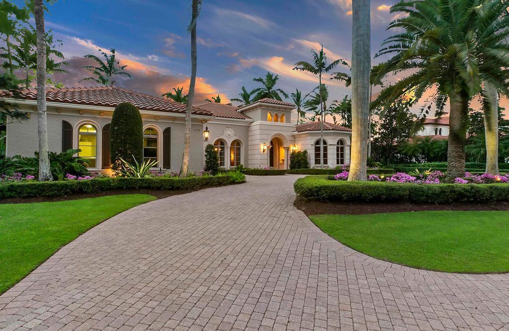 11701 San Sovino Court, Palm Beach Gardens, Florida is a private enclave on one of the most coveted streets within Old Palm Golf Club with tropical water feature view, expansive covered lanai, breezy awnings, heated pool & spa and more.