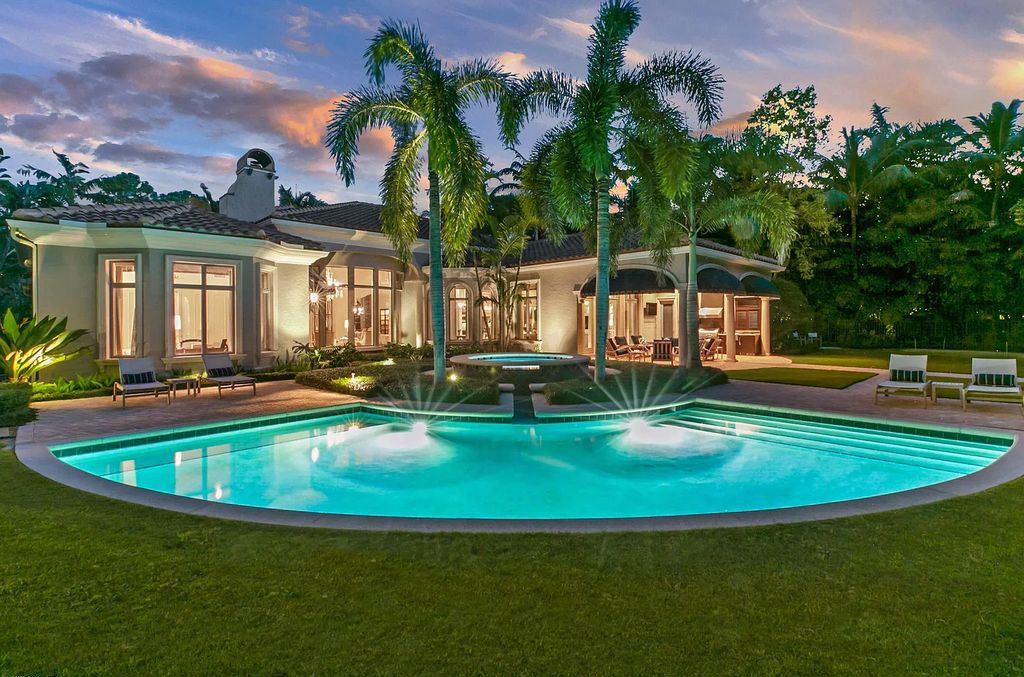 11701 San Sovino Court, Palm Beach Gardens, Florida is a private enclave on one of the most coveted streets within Old Palm Golf Club with tropical water feature view, expansive covered lanai, breezy awnings, heated pool & spa and more.