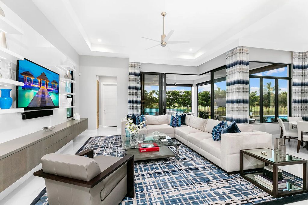17121 Brulee Breeze Way, Boca Raton, Florida is a sprawling lakefront masterpiece brimming with clean lined sophistication features the highest level of finishes, privacy and timeless design by Susan LaChance Interiors.