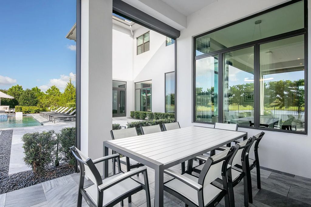 17121 Brulee Breeze Way, Boca Raton, Florida is a sprawling lakefront masterpiece brimming with clean lined sophistication features the highest level of finishes, privacy and timeless design by Susan LaChance Interiors.