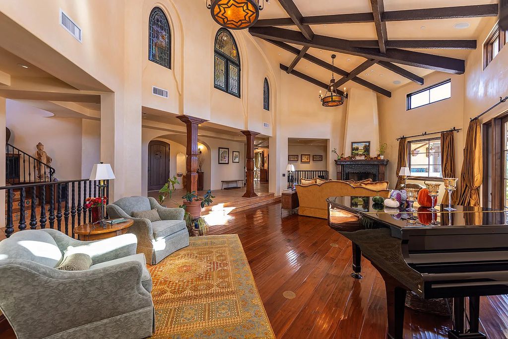 561 Saddle Lane, Ojai, California is a majestic Mediterranean-style home has flowing curves, arched doorways, and cathedral ceilings with exposed hand-hewn beams and clerestory windows.