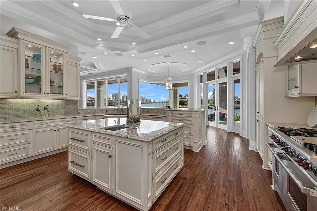 211 Bay Point, Naples, Florida is a classic Key West style home with over 100 ft waterfrontage has complete hurricane protection, wood paneling ceilings on the lanai, built in summer kitchen.