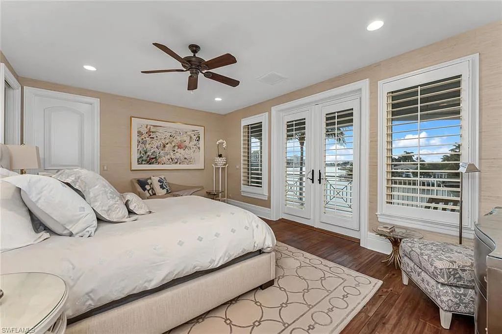211 Bay Point, Naples, Florida is a classic Key West style home with over 100 ft waterfrontage has complete hurricane protection, wood paneling ceilings on the lanai, built in summer kitchen.