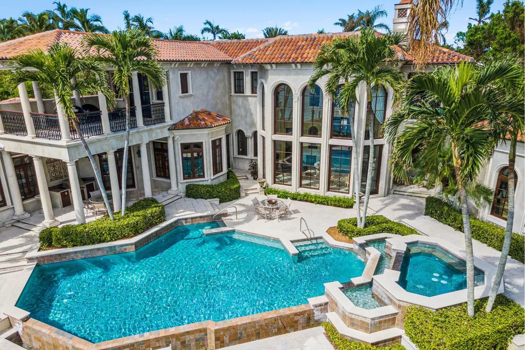950 Admiralty Parade East, Naples, Florida is a custom estate on one and a half lots in the coveted Port Royal neighborhood encompassing a handsome downstairs study, 3 car garage plus the ability for lifts, separate guest casita over the garage and private elevator.