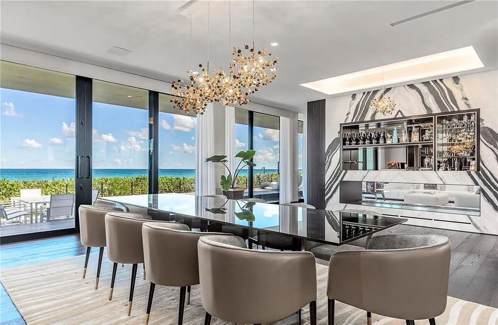 1005 NE Doubloon Drive, Stuart, Florida is one of the most iconic homes on the Treasure Coast marries contemporary design with utter livability, featured amenities include 2 separate garages, fitness center, theatre, game room, lounge, outdoor shower, basketball, and waterscapes.
