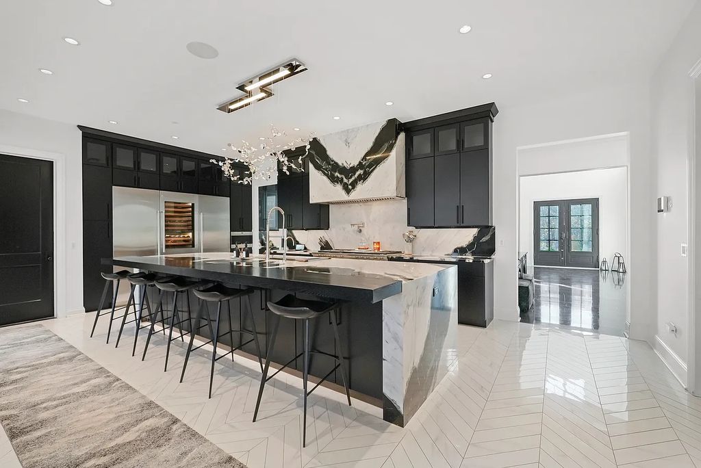 The Estate in Lincolnshire offers a grand scale foyer, ebony oak floors, an open floor plan, soaring ceiling heights, custom luxury finishes throughout now available for sale. This home located at 23477 N Elm Rd, Lincolnshire, Illinois