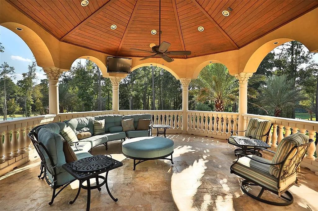 38262 Windy Ridge Trail, Magnolia, Texas is a sprawling home set on 20+ac resort-like grounds with features includes twin wrought-iron staircases, custom chandeliers, 2-story library, games room plus pub and more.