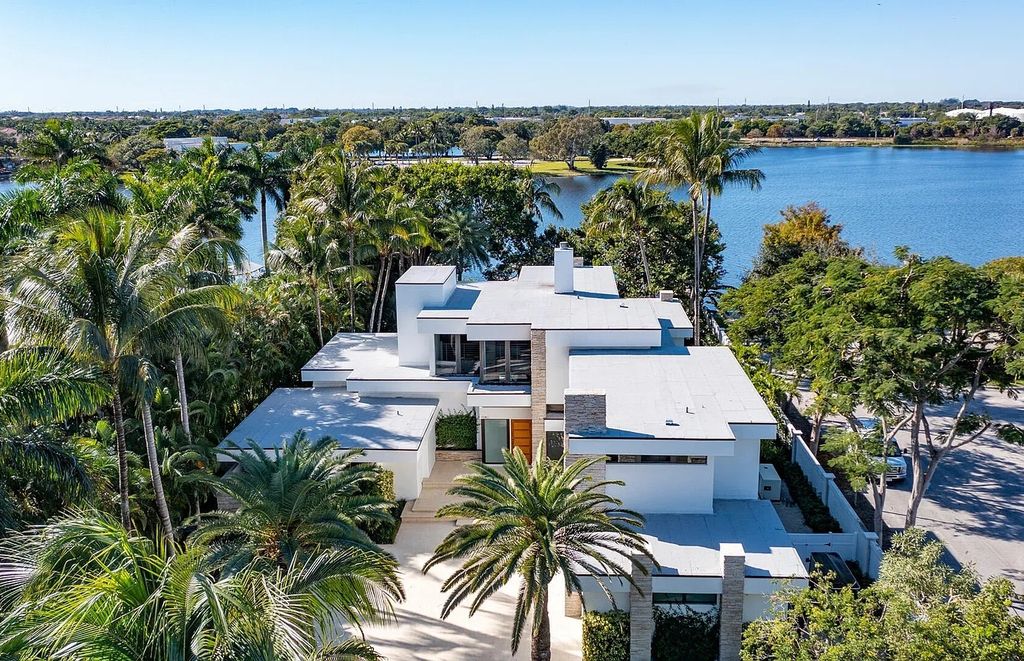 1080 Lake Drive, Delray Beach, Florida is a Frank Lloyd Wright-inspired estate perfect for water-sports enthusiasts are a boat house and dock, and inviting indoor outdoor entertaining, two loggias overlook the pool. 