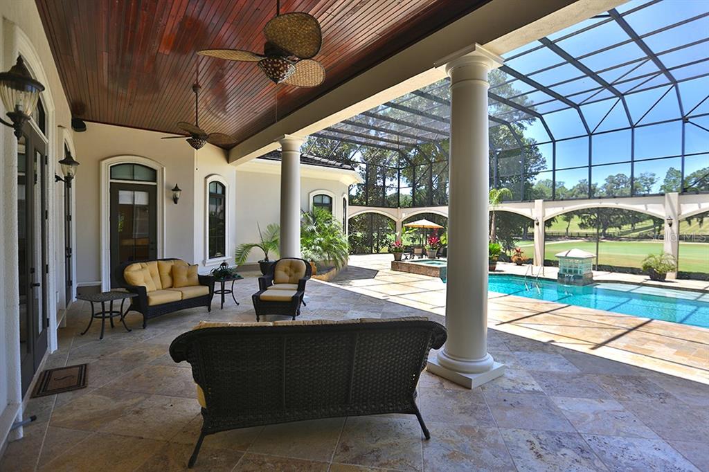 3956 NW 85th Terrace, Ocala, Florida is a spectacular residence perfect for family living and entertaining with open floor plan, resort style screen enclosed pool, summer kitchen, beautiful sunsets overlooking the golf course.