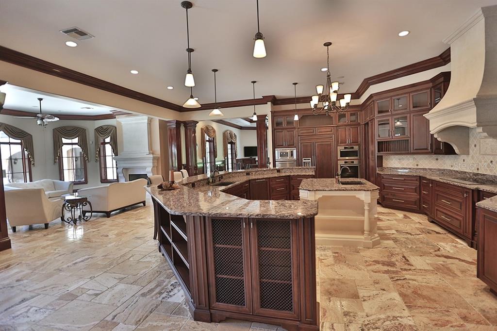 3956 NW 85th Terrace, Ocala, Florida is a spectacular residence perfect for family living and entertaining with open floor plan, resort style screen enclosed pool, summer kitchen, beautiful sunsets overlooking the golf course.