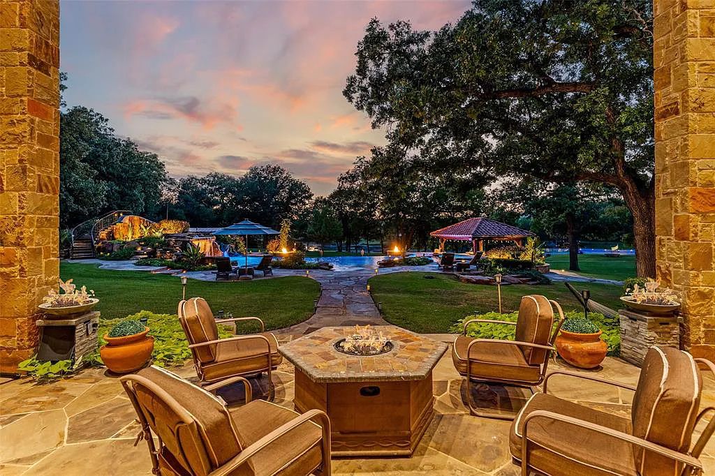 127 River Oak Court, Weatherford, Texas is a one of a kind estate for the luxurious recreational and residential experience with features including large pool with infinity edge, water fall, slide, swim up bar, and extensive decorative lighting.