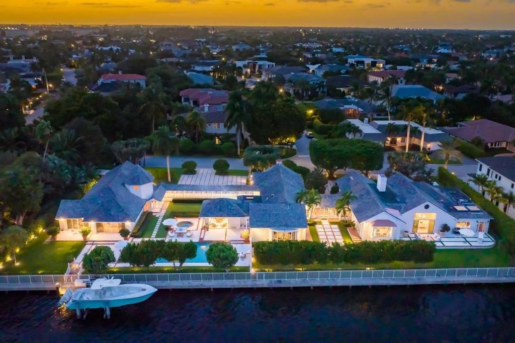 2408 E Maya Palm Drive, Boca Raton, Florida is a sprawling Hampton's Farmhouse-inspired home on Royal Palm Yacht & Country Club's prestigious Intracoastal and sited on 2.5 lots with 261+/- feet of rare waterfrontage. This Home in Boca Raton offers 6 bedrooms and 9 bathrooms with over 5,500 square feet of living spaces.