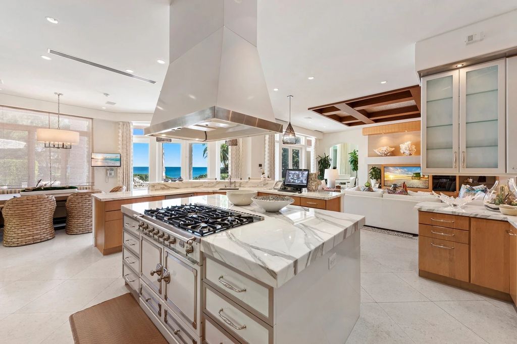 317 Ocean Boulevard, Golden Beach, Florida is an exceptional ocean front estate with luxurious amenities including formal dining room with maple paneling, movie theater, elevator, help quarters, finished basement, gym, and 2 large storage rooms. 