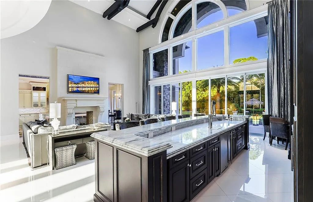 482 Ridge Drive, Naples, Florida, is located in a desirable Naples neighborhood, just minutes from Vanderbilt Beach, Mercato, and Waterside shops. This stunning home was built with meticulous attention to detail, including a butterfly staircase and marble floors.