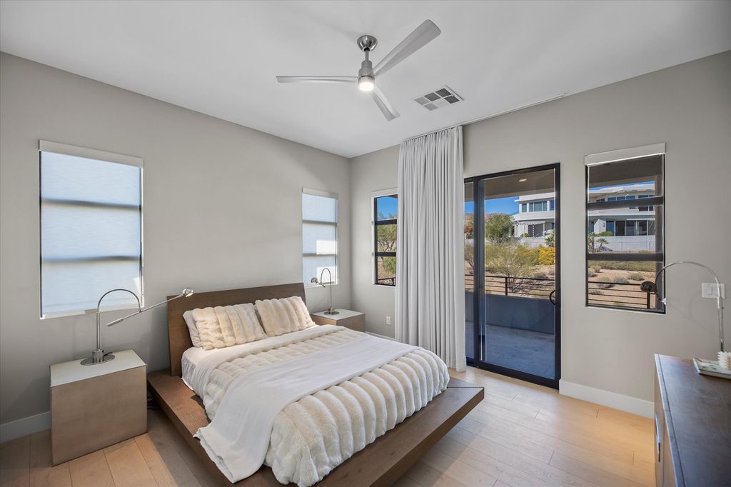 The modest brown bed frame, plush shearling throw, plain nightstand, and neutral lamp are the only focal points of this bedroom. By simplifying a neutral area, each piece can shine while maintaining the precise level of tranquility a bedroom requires.