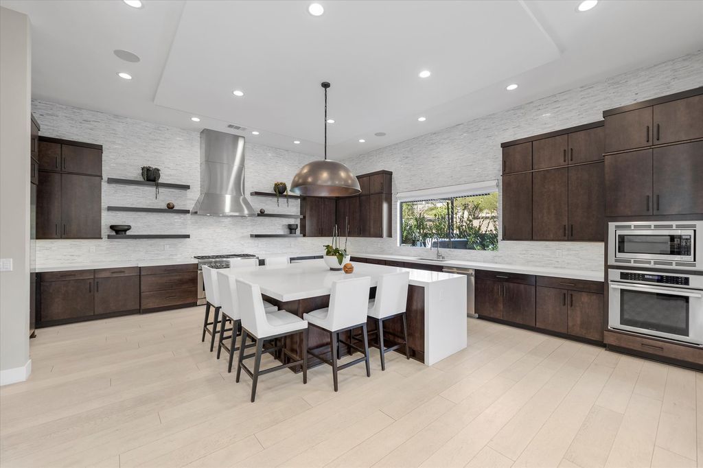 11448 Opal Springs Way, Las Vegas, Nevada is a guard-gated designer dream home with updated amenities including French oak hardwood flooring, silver travertine decking, closets, light fixtures, Control4 home automation, whole-home sound, and more.