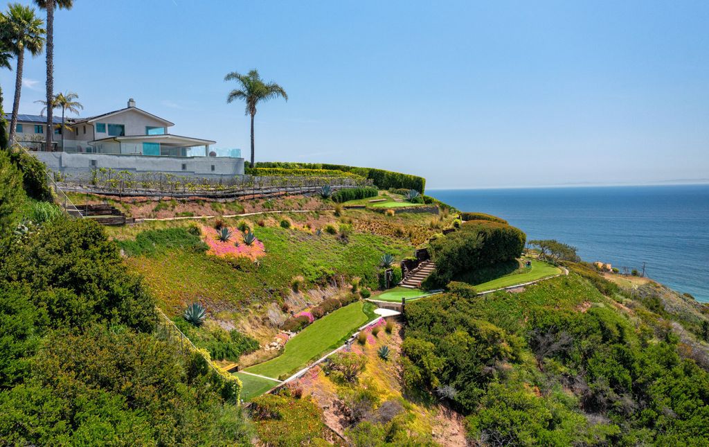 22407 Carbon Mesa Road, Malibu, California is truly a golfer's retreat in a spectacular, verdant setting on a gated promontory of more than two manicured acres on two parcels, views that take in a panorama of ocean, islands, and coastline from Point Dume and the Malibu Pier to Palos Verdes.