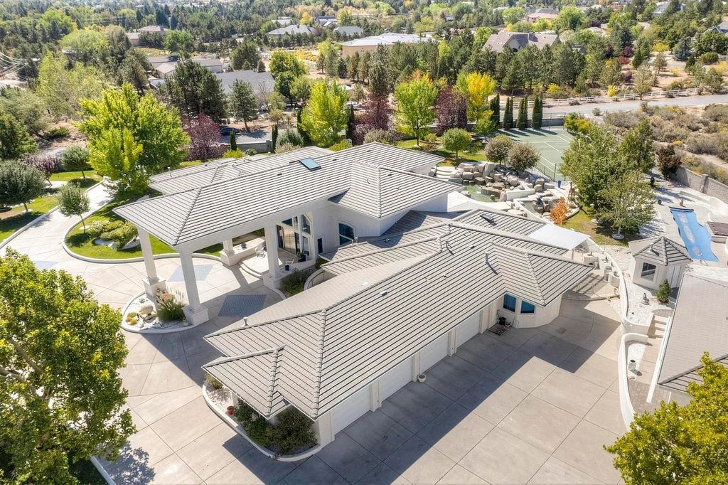 1860 N Winnie Lane, Carson City, Nevada is a well appointed home built with privacy and comfort in mind from stunning mountain views and serene waterfalls to staying active with your very own tennis court and built-in heated pool with waterfall. 
