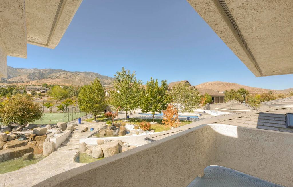 1860 N Winnie Lane, Carson City, Nevada is a well appointed home built with privacy and comfort in mind from stunning mountain views and serene waterfalls to staying active with your very own tennis court and built-in heated pool with waterfall. 