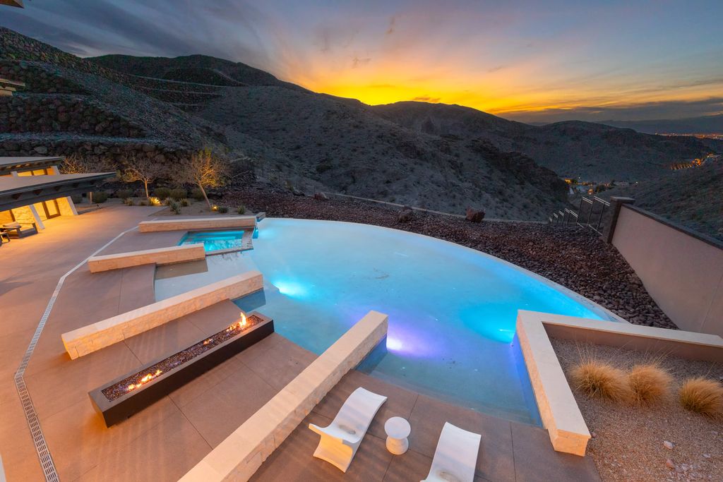 19 Sanctuary Peak Court, Henderson, Nevada is a custom sanctuary designed by Swaback Partners presents an artistic juxtaposition of light vs seclusion, rounded edges vs geometric angles, and spectacular realism vs illusion. 