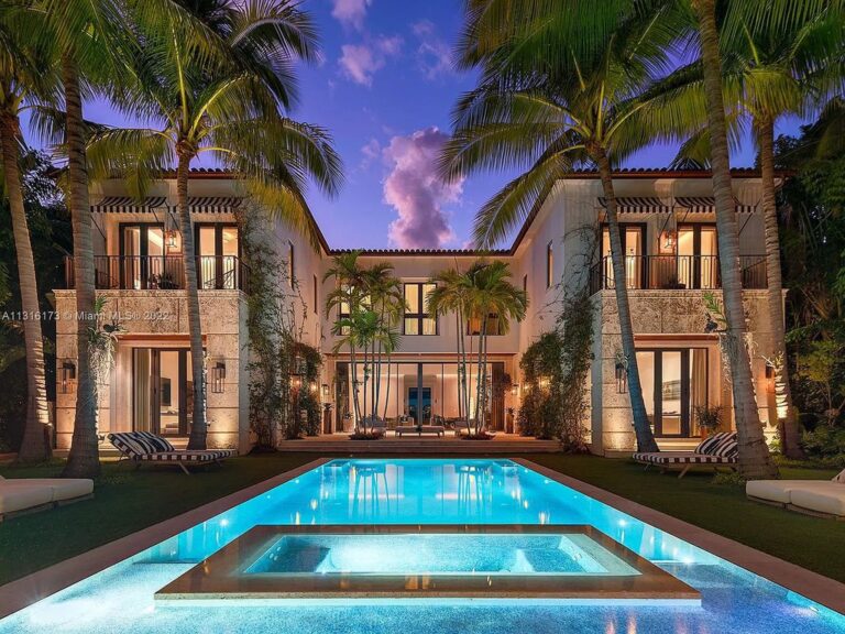 An Elegant Villa in Miami Beach Featuring an Overflowing Perimeter Pool and Bar with A Floating Fireplace