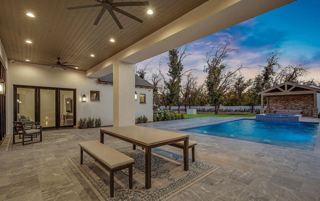 20509 E Cloud Road, Queen Creek, Arizona is a extraordinary property with the outdoor space has bluestone pavers, a large pool and spa, outdoor kitchen, outdoor fireplace, outdoor pizza oven, mature pecan trees and an assortment of professionally designed landscaping.
