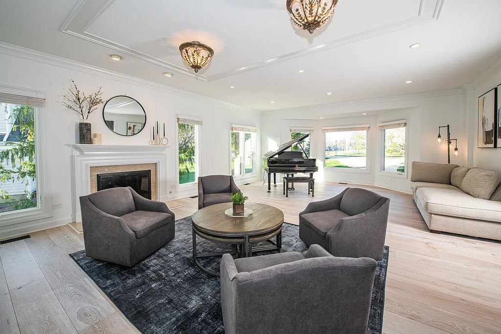 The Home in North Barrington has an elegant white brick exterior, dramatic circular driveway, heated four-car garage loaded with storage space, now available for sale. This home located at 23 Hallbraith Ct, North Barrington, Illinois